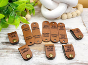 Coffee saying tags shown folded with rivet attachment