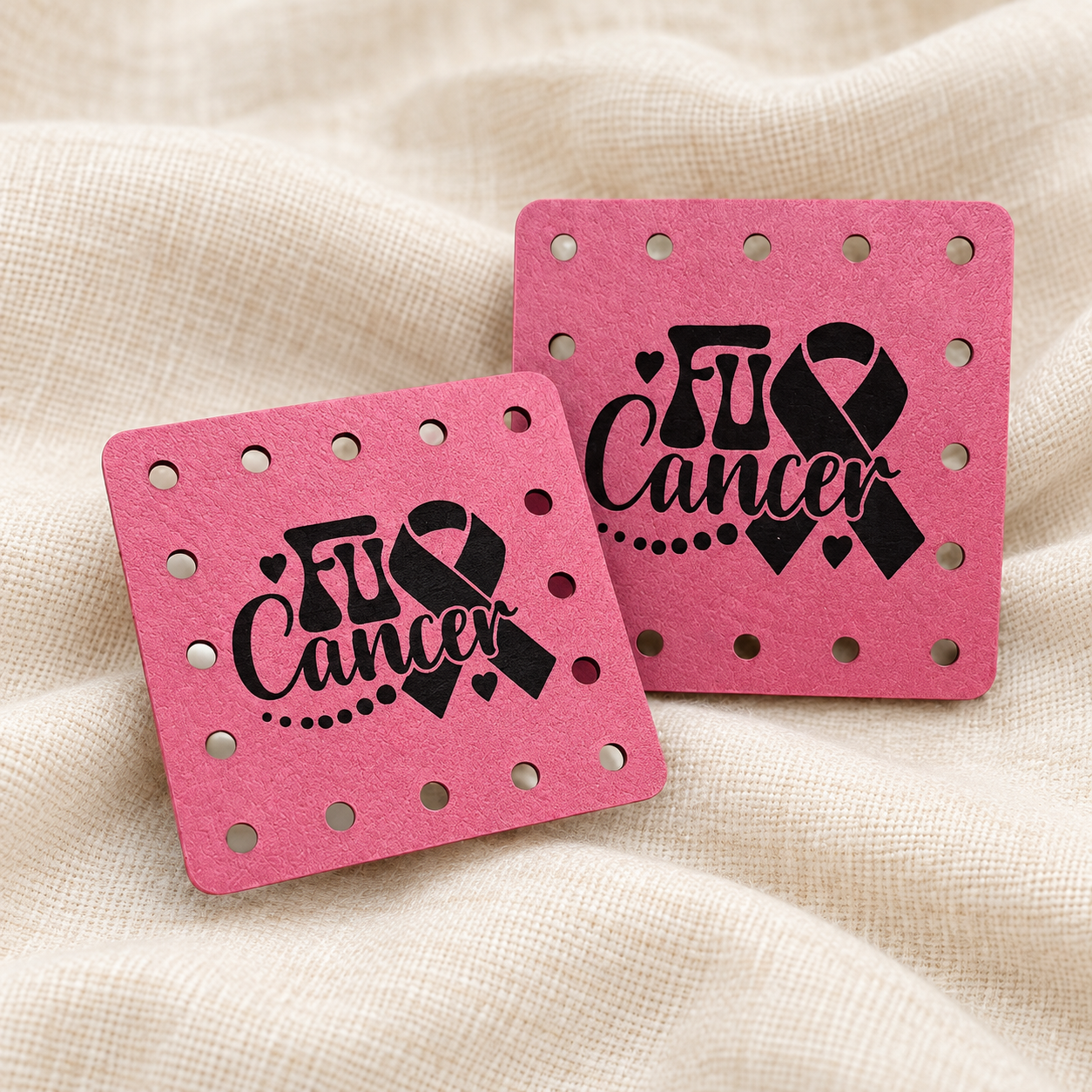FU Cancer engraved faux leather sew-on patches on a cream background