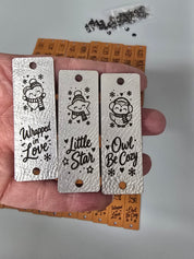 Three metallic silver kids tags with Wrapped in Love, Little Star and Owl Be Cozy sayings
