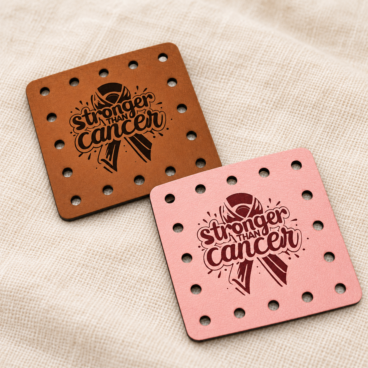 Stronger Than Cancer engraved faux leather sew-on patches on a cream background